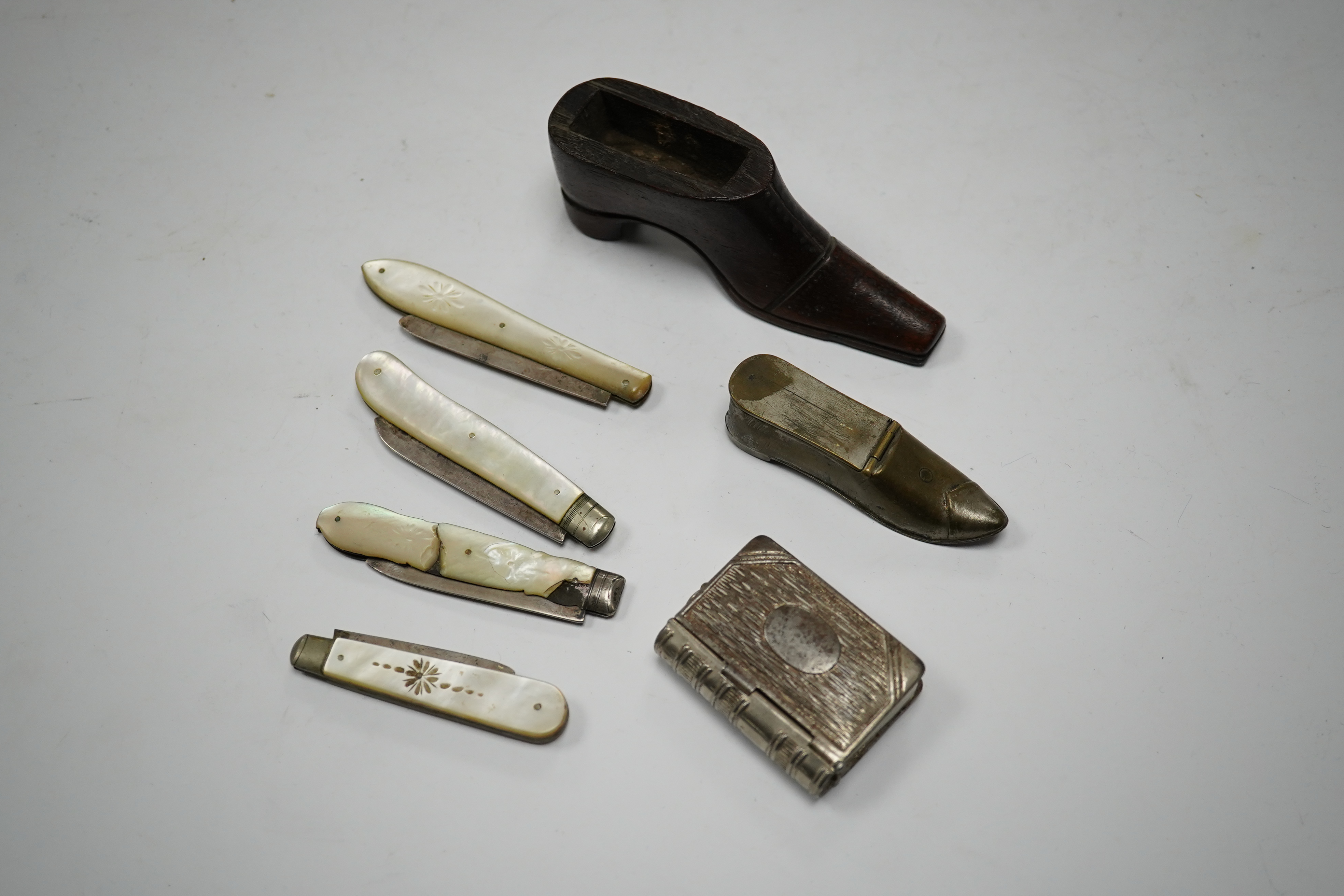 Four mother-of-pearl penknives, two vesta cases and a treen shoe, treen shoe 10cm long. Condition - fair